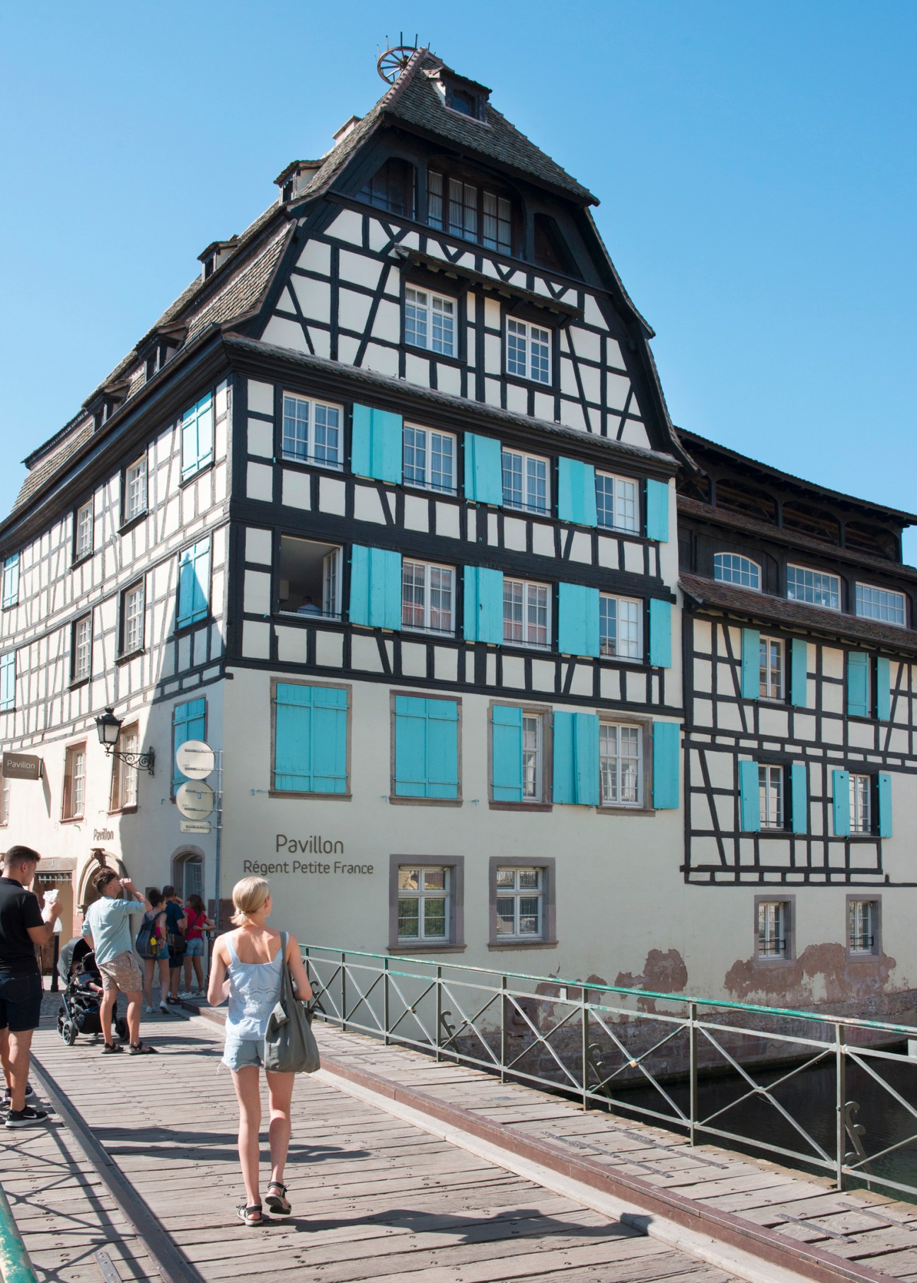 Traditional half-timbered house with blue shutters and timber framing in Strasbourg's Petite France district