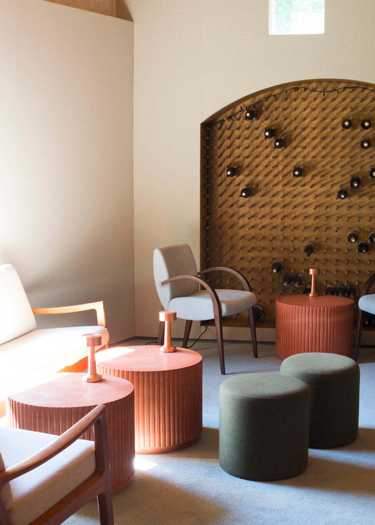 Modern restaurant interior at Enfin with contemporary furniture, warm lighting, and exposed stone walls