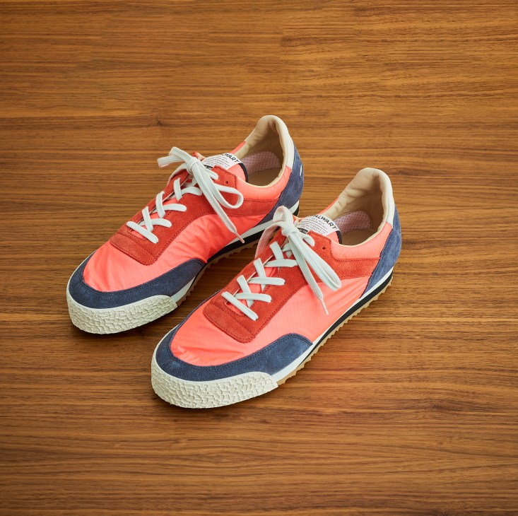Spalwart retro-style trainers in coral pink and navy blue colorway on wooden floor