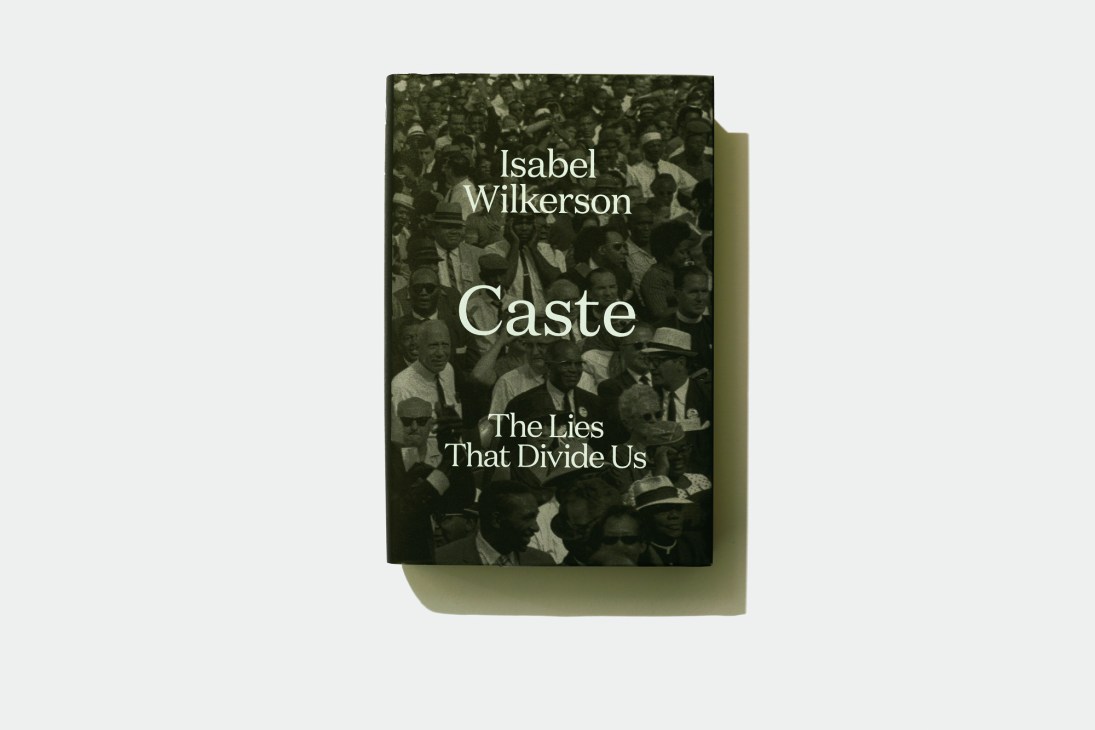 Book cover of 'Caste: The Lies That Divide Us' by Isabel Wilkerson featuring a historical black and white photograph.