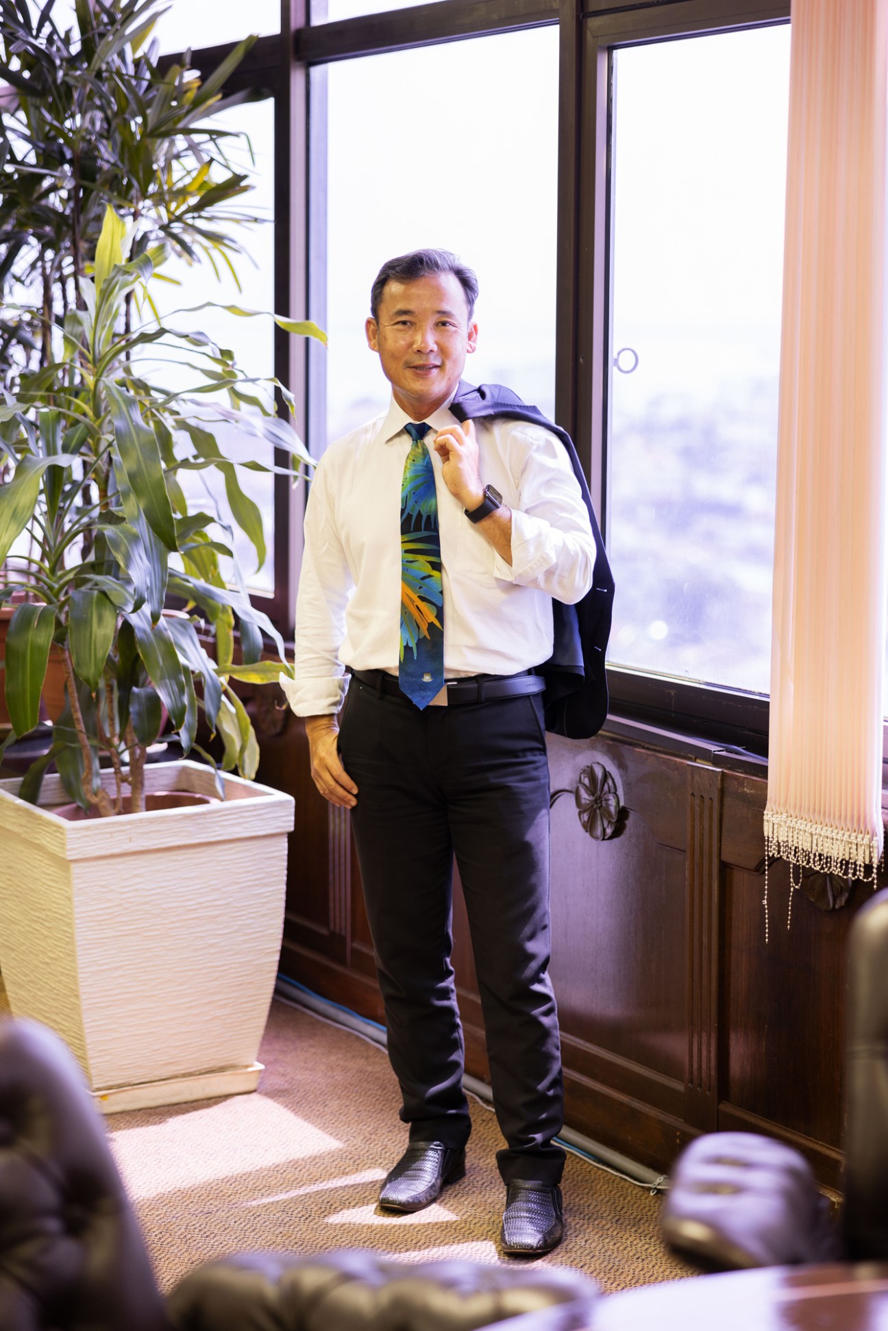 Yew Tung Seang, mayor of Penang, standing in formal business attire in an office with large windows