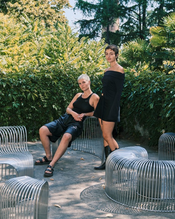 Josefin Zachrisson and Mira Bergh of Swedish Girls standing on modern metal wire outdoor furniture