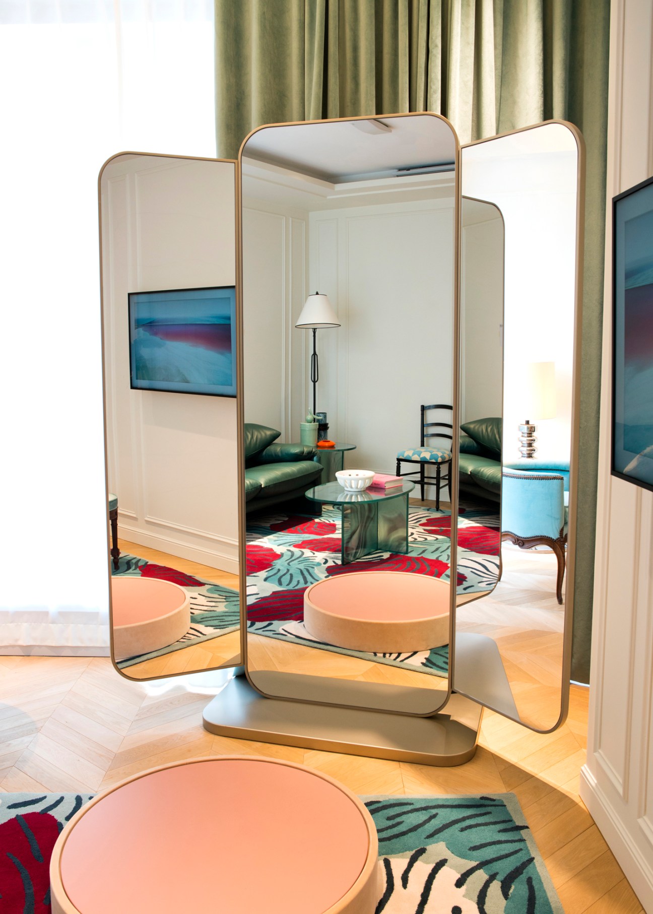 Private room for VIP clients with three-panel mirror, colorful rug, and seating area