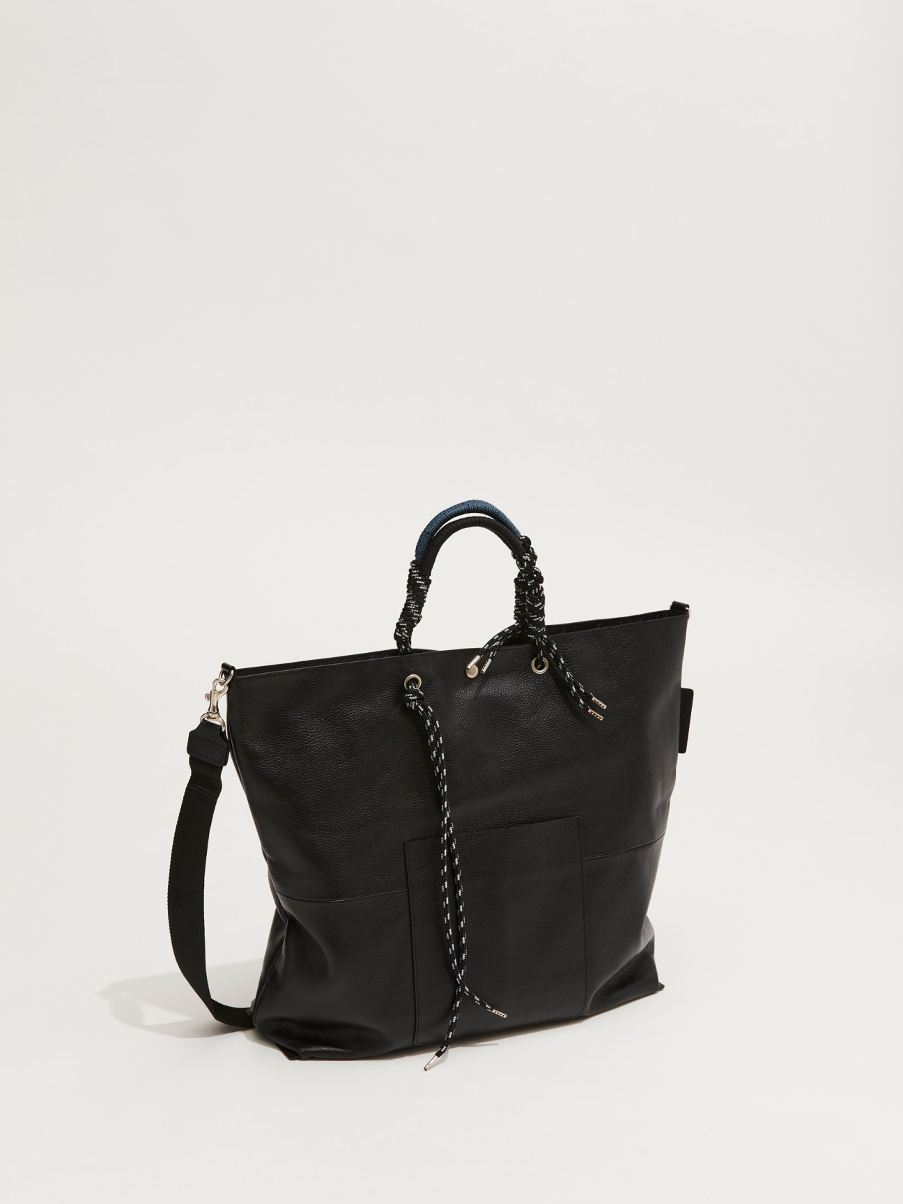 Black leather tote bag with rope handles and drawstring closure against white background
