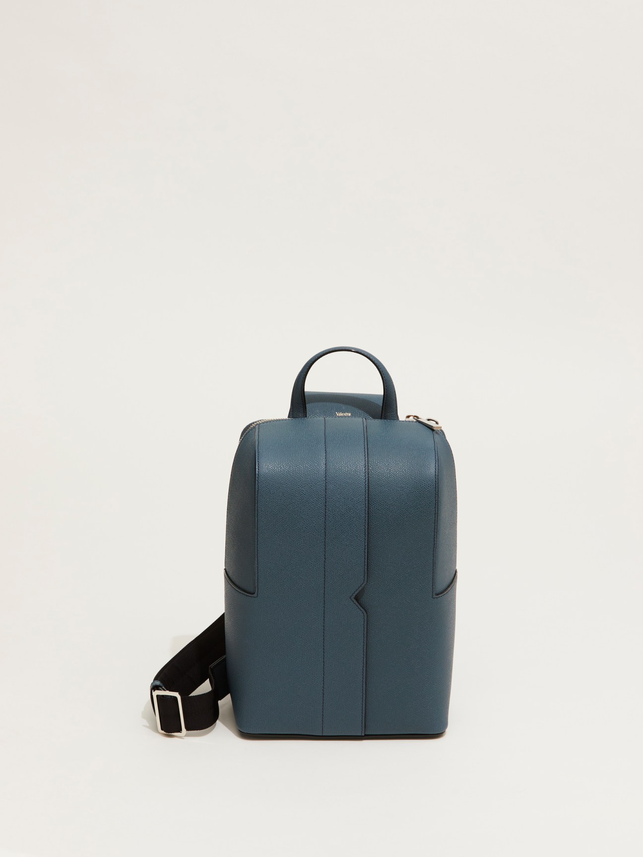 V-line one-shoulder bag by Valextra in blue leather on neutral background