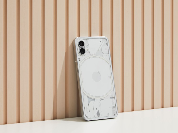 Nothing Phone (1) with transparent case showing internal components and circular wireless charging coil