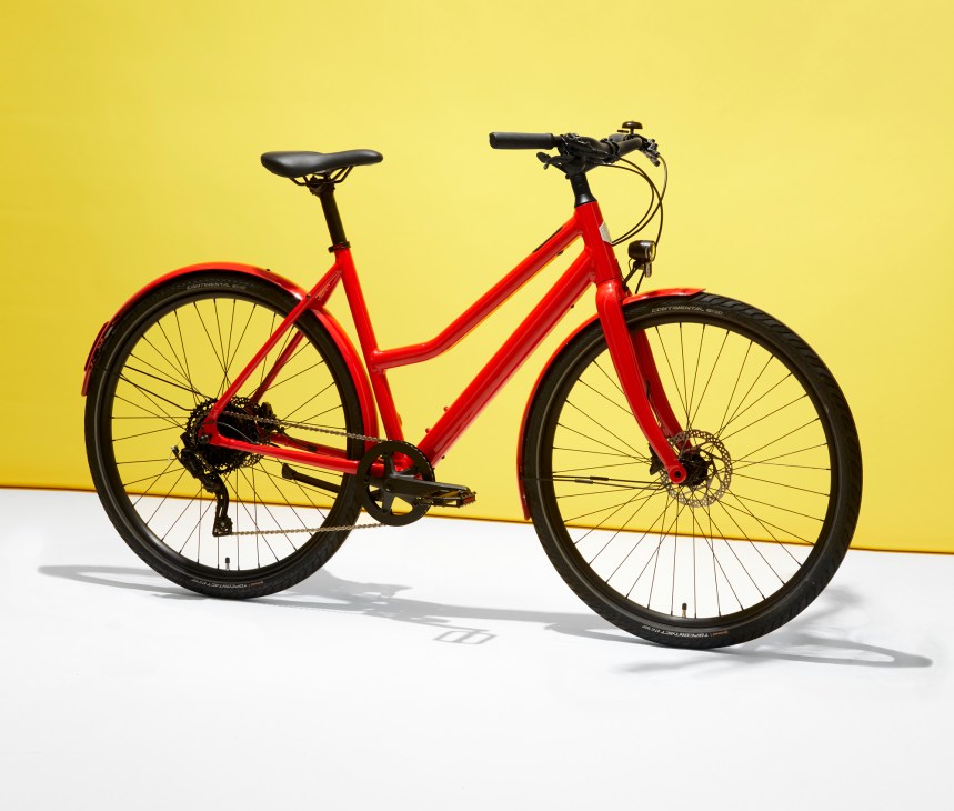 Red Ampler Stellar e-bike with step-through frame against yellow background