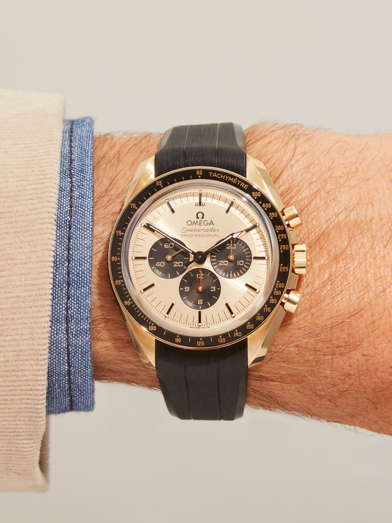 Omega Speedmaster Moonshine Gold chronograph watch with cream dial and black subdials on leather strap