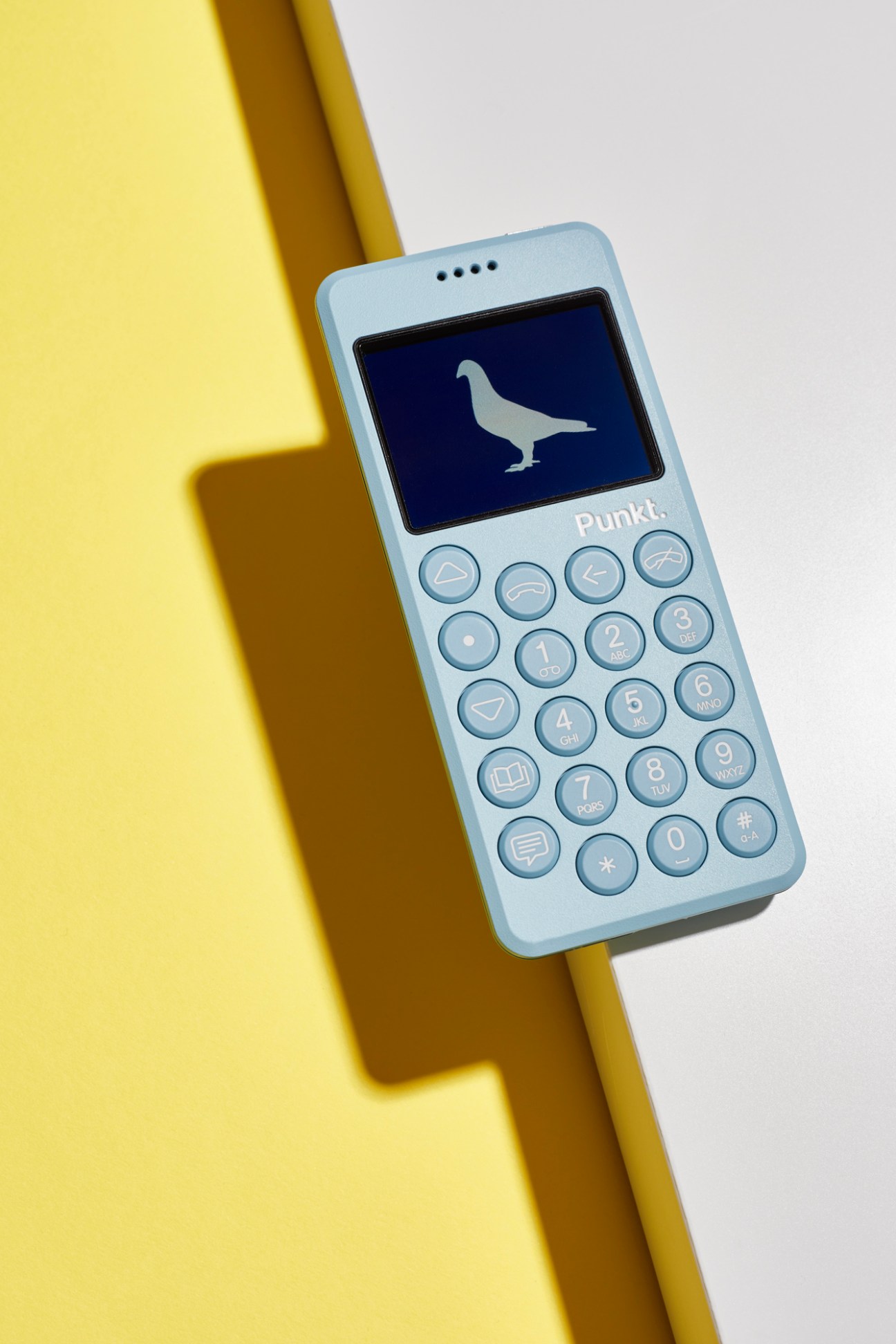 Punkt MP02 mobile phone in pale blue showing minimalist design with physical keypad and small screen