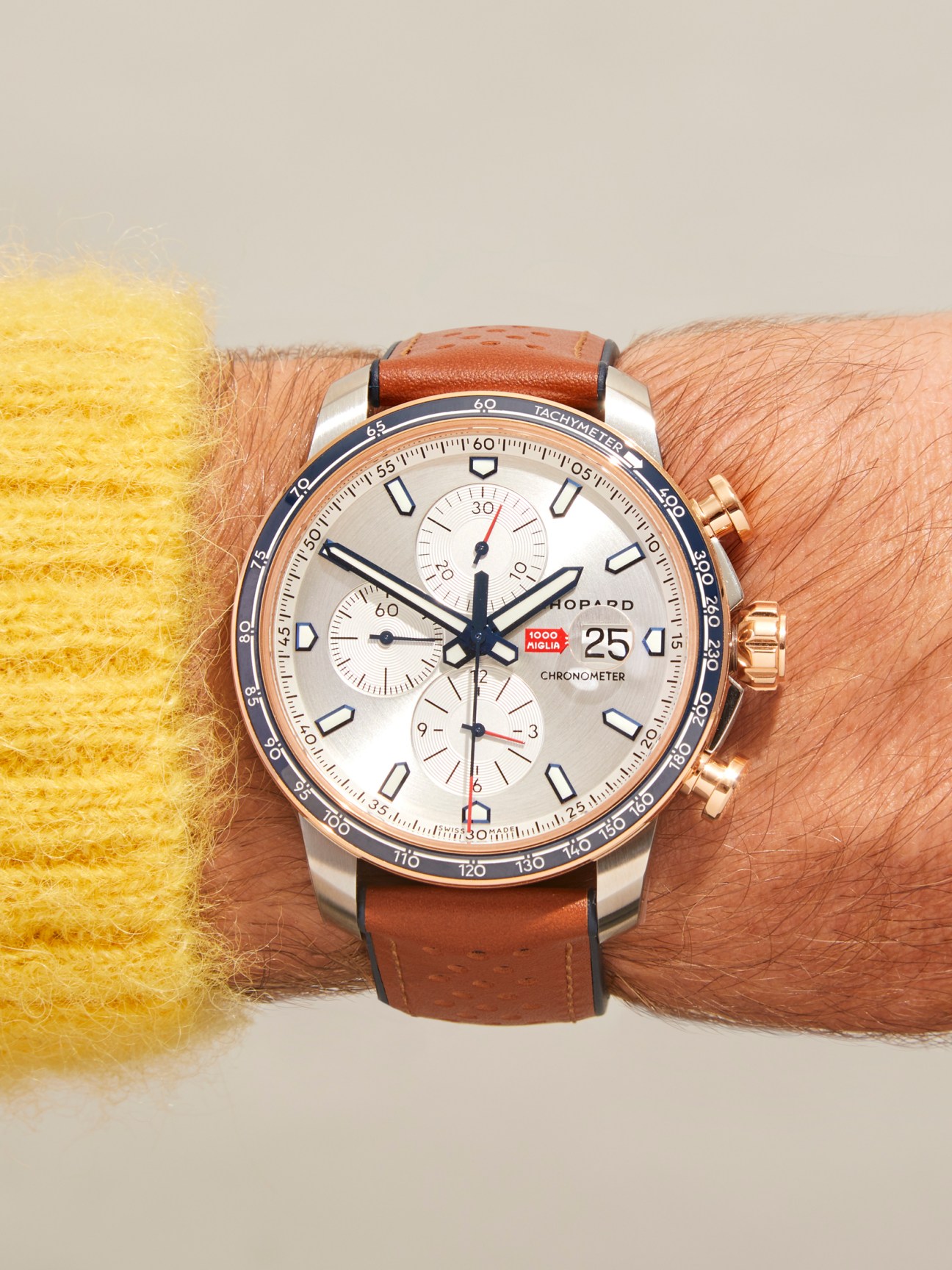 Chopard Mille Miglia chronograph watch with white dial, brown leather strap and tachymeter bezel worn on wrist