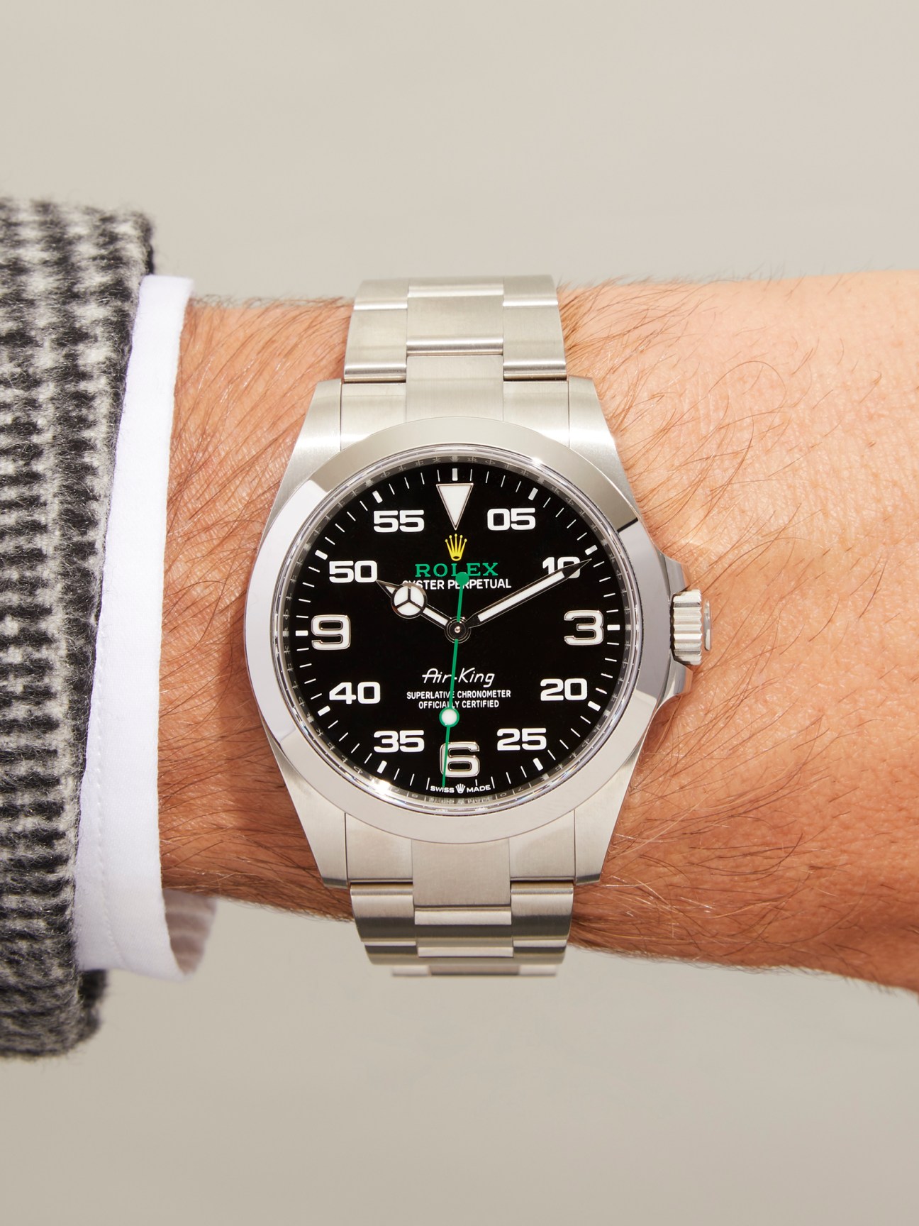 Rolex Air-King watch with black dial and stainless steel bracelet worn on wrist