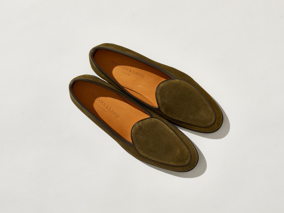 Olive green suede loafer shoes by Baudoin & Lange with orange leather interior on white background