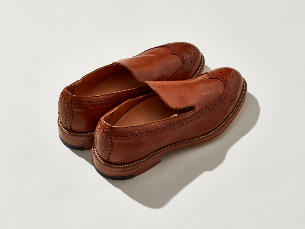 Brown leather wingtip slip-on shoes with brogue detailing by Yuketen