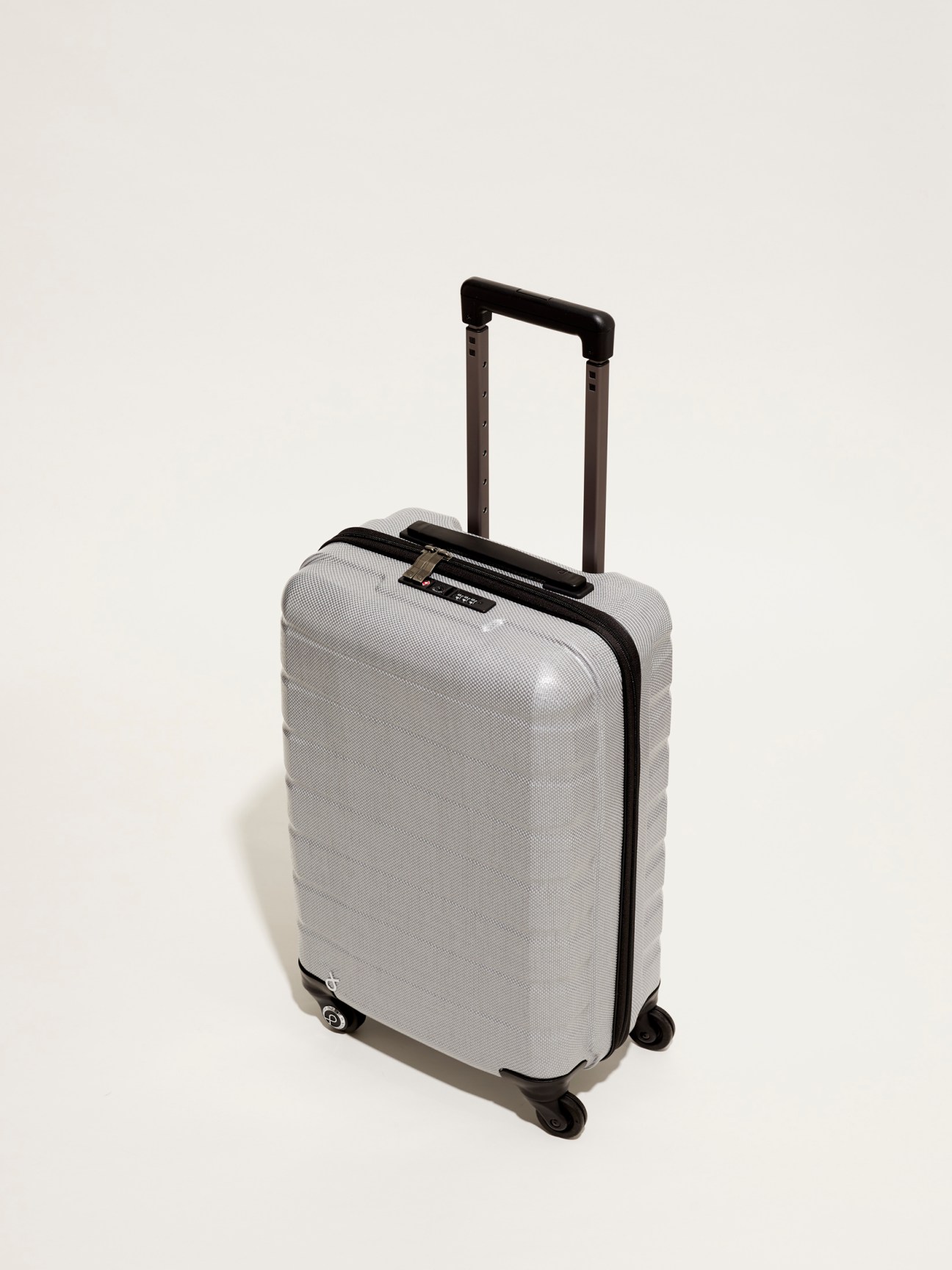 Silver hard-shell suitcase with black handle and wheels by Proteca