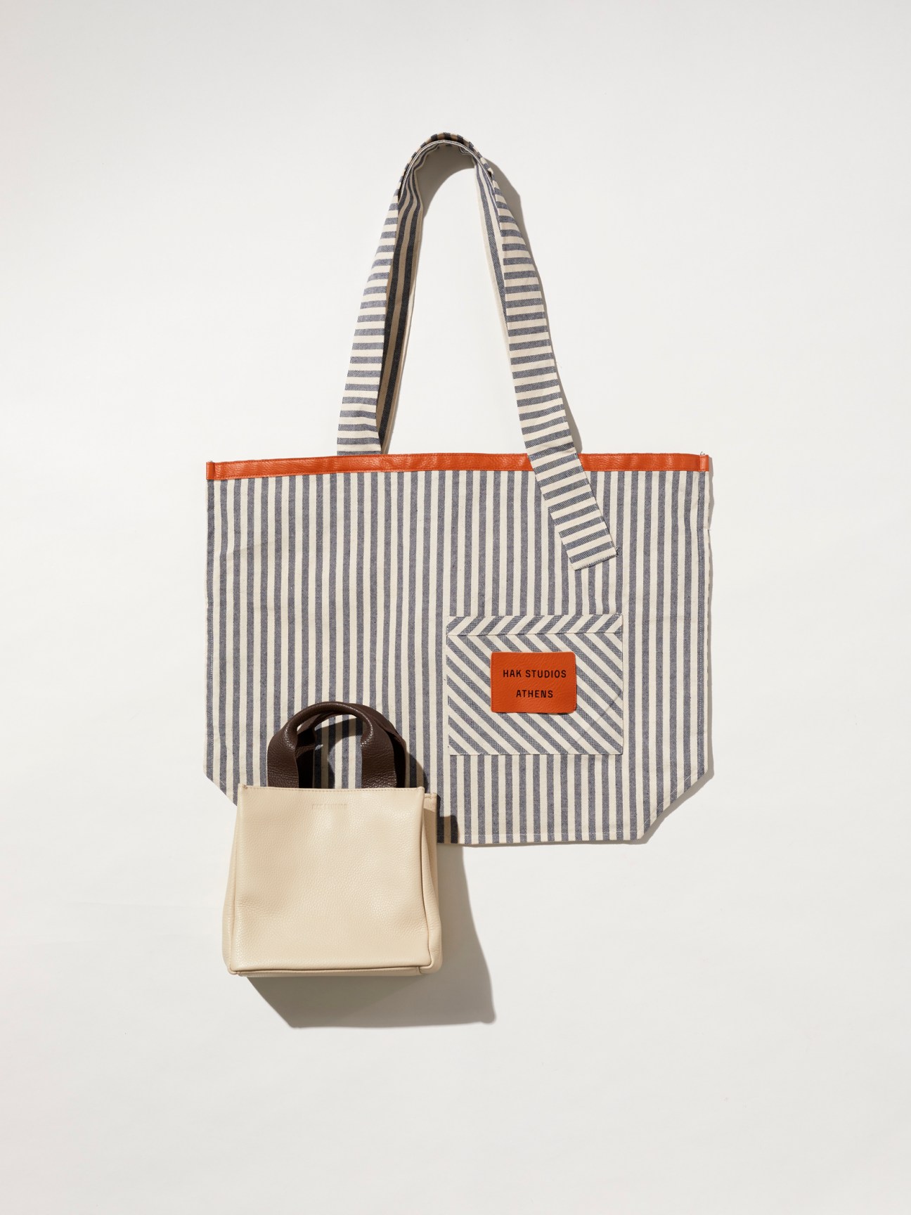 Striped canvas tote bags and cream leather handbag from Hak Studios Athens