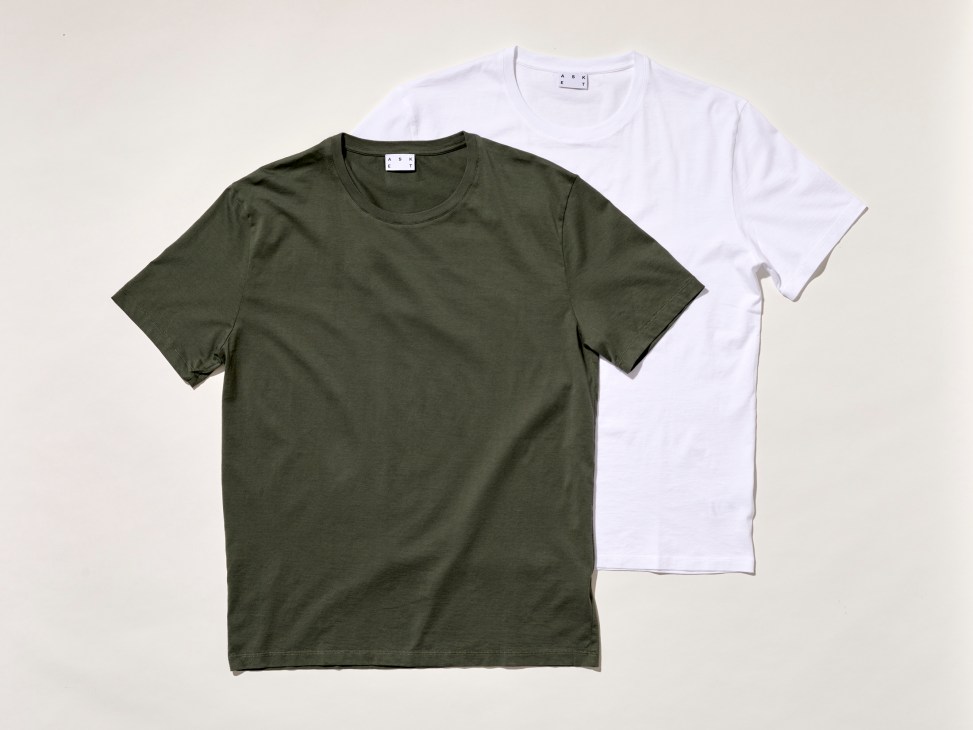 Two plain t-shirts, one olive green and one white, laid flat against a light background