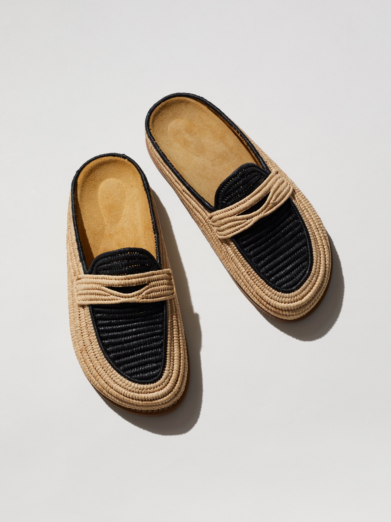 Contre Allée handwoven raffia loafers in natural and black tones displaying Moroccan craftsmanship