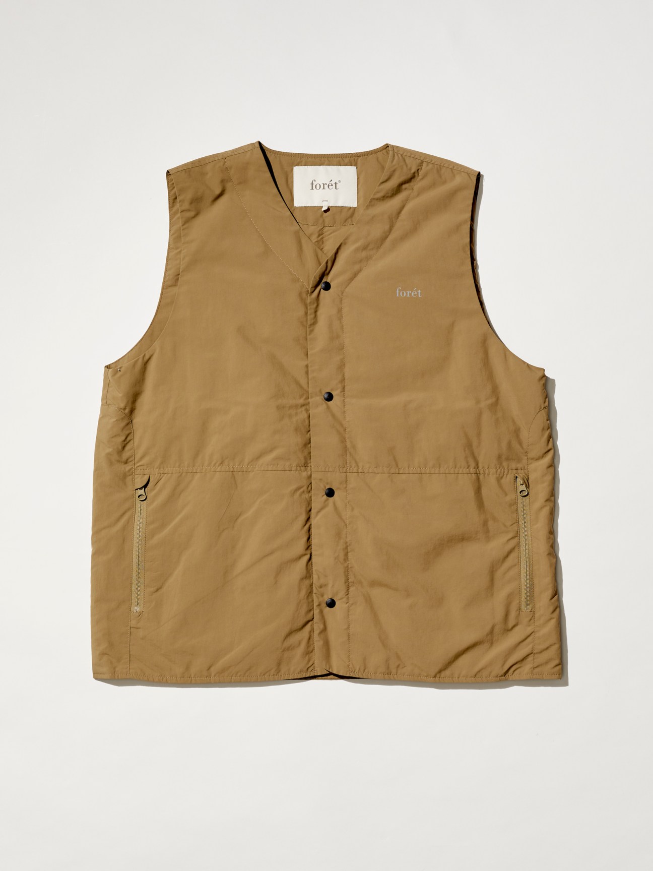 khaki sleeveless vest with snap buttons and zippered pockets from outdoor clothing brand Forét
