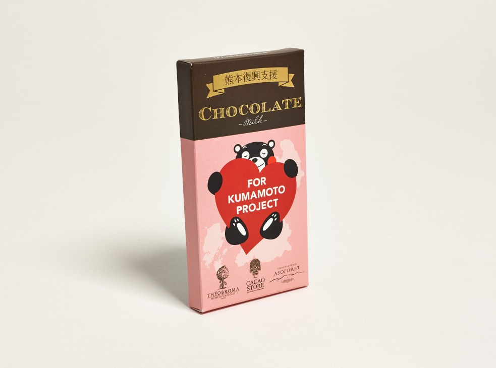 Milk chocolate bar packaging with Kumamon branding and Japanese text on brown and pink box design