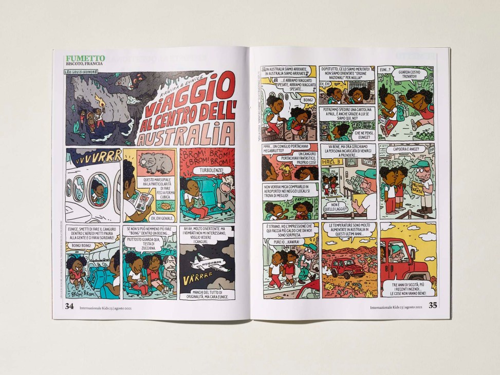 Open magazine pages showing colorful comic strip illustrations in Italian about a journey to Australia.