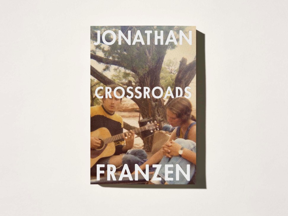 Book cover showing Jonathan Franzen's Crossroads with two people playing guitar under a tree