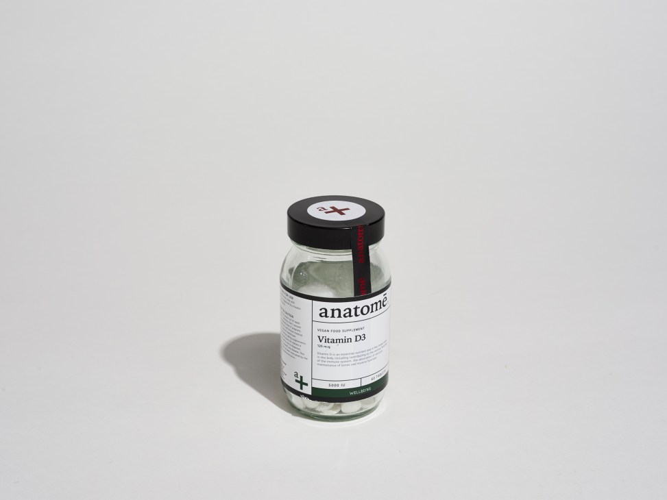 Anatome Vitamin D3 supplement bottle with black cap on white background.