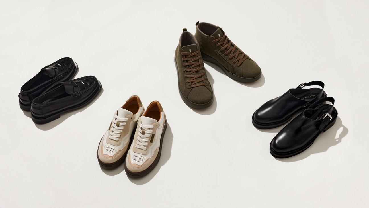 Four pairs of shoes displayed on white background: black loafers, cream and tan trainers, olive lace-up boots, and black mules.