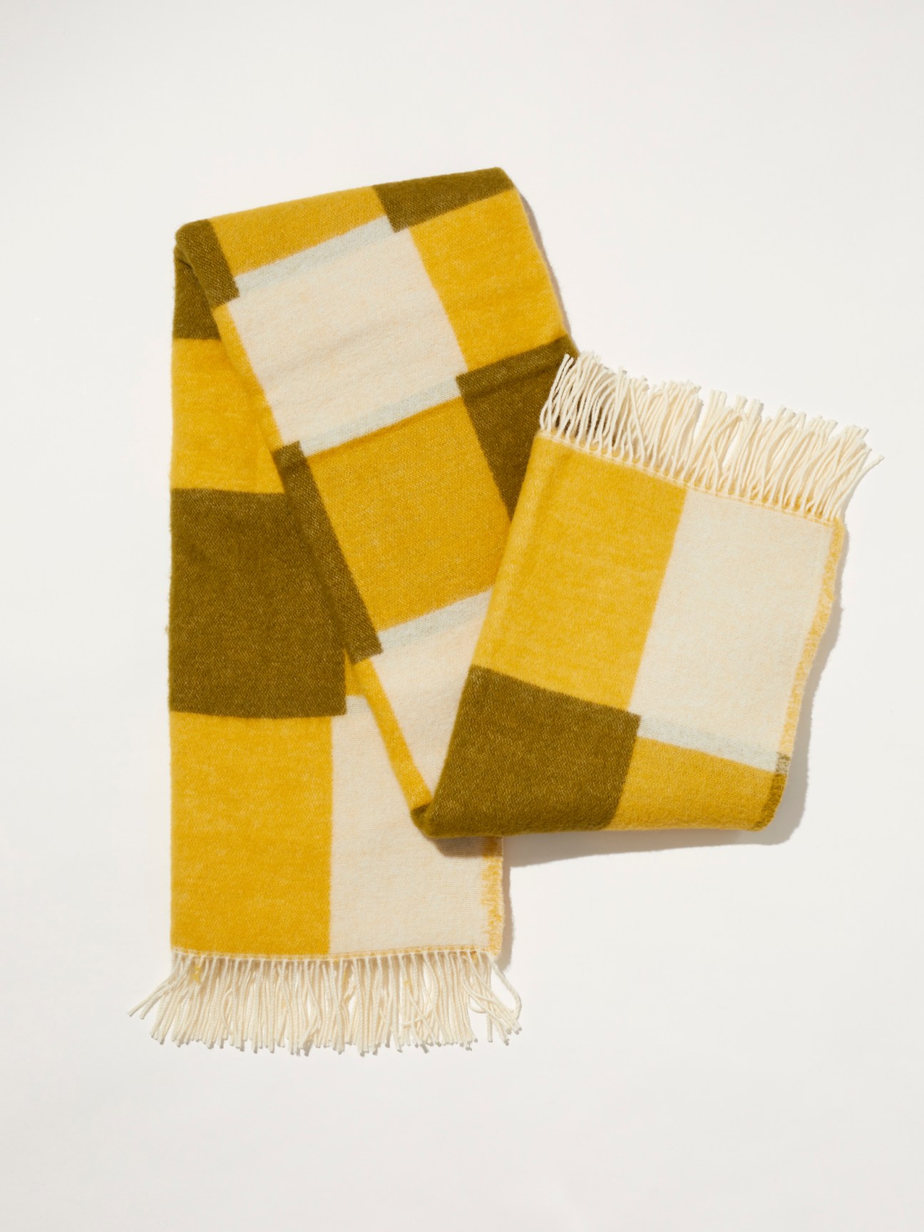 Mustard and khaki graphic check pattern blanket made from soft lambswool by Arket and Evelina Kroons