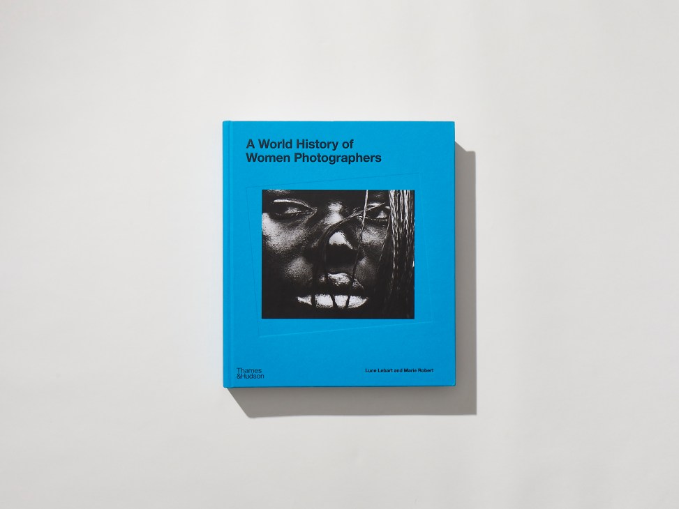 Blue book cover titled A World History of Women Photographers with black and white portrait photograph