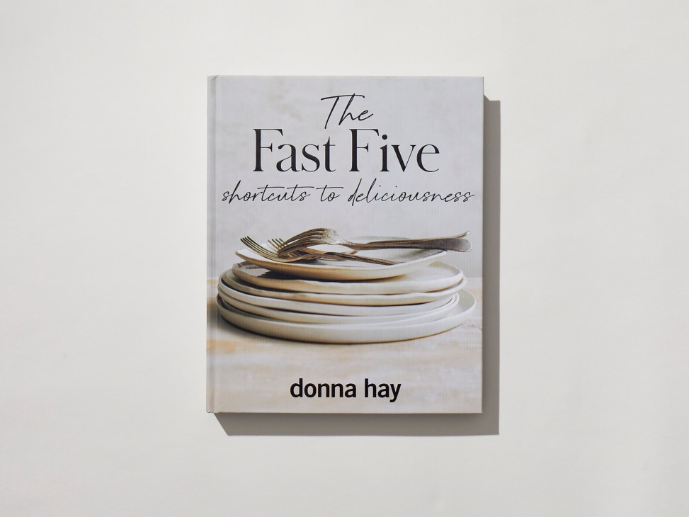 The Fast Five by Donna Hay cookbook cover showing stacked white plates with gold cutlery