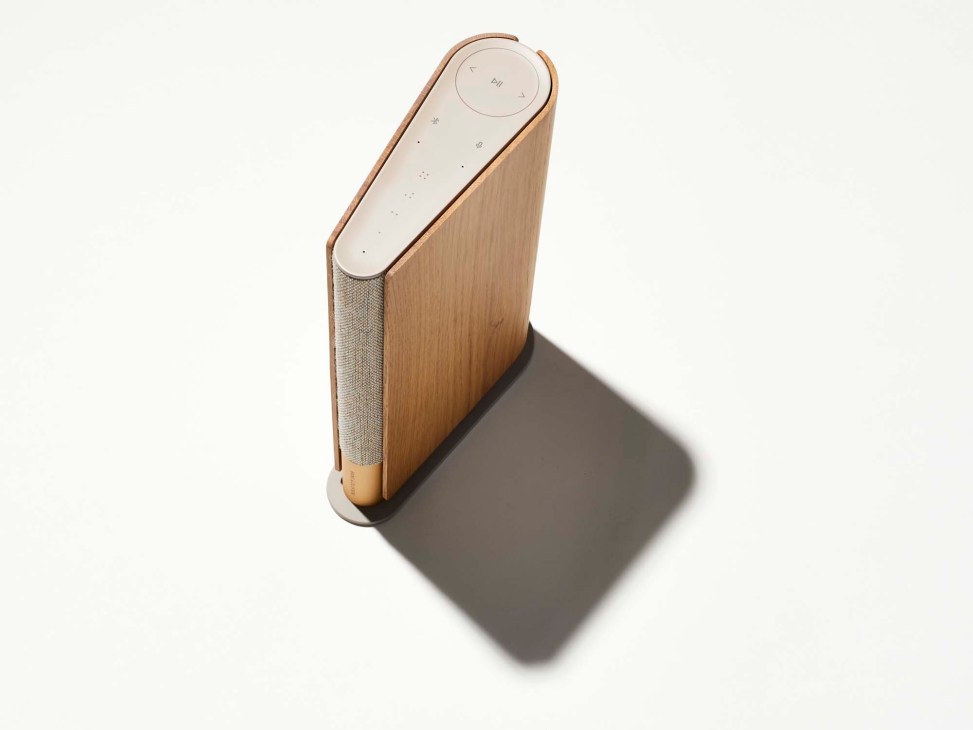 Bang & Olufsen Beosound Emerge smart speaker with wood and fabric design on white background