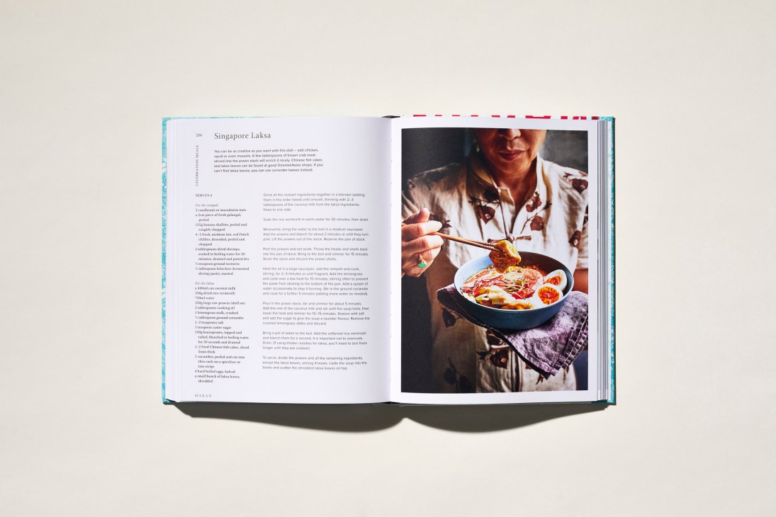 Chef Elizabeth Haigh holding her Makan cookbook