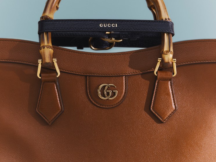 Brown leather Gucci handbag with bamboo handle and gold hardware featuring the iconic GG logo