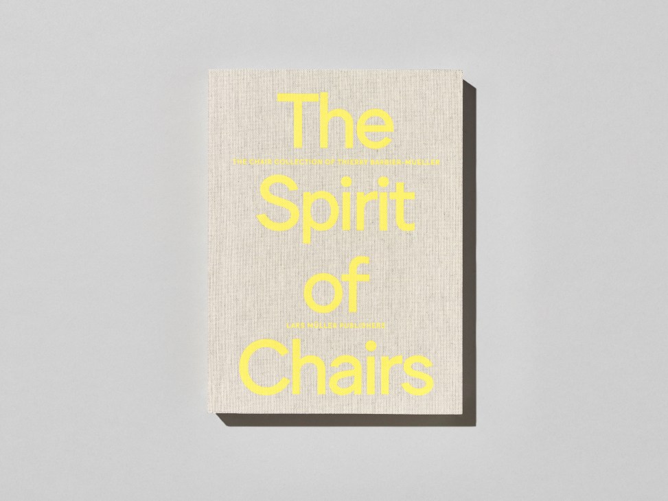 Book cover with yellow text reading 'The Spirit of Chairs' on beige textured background