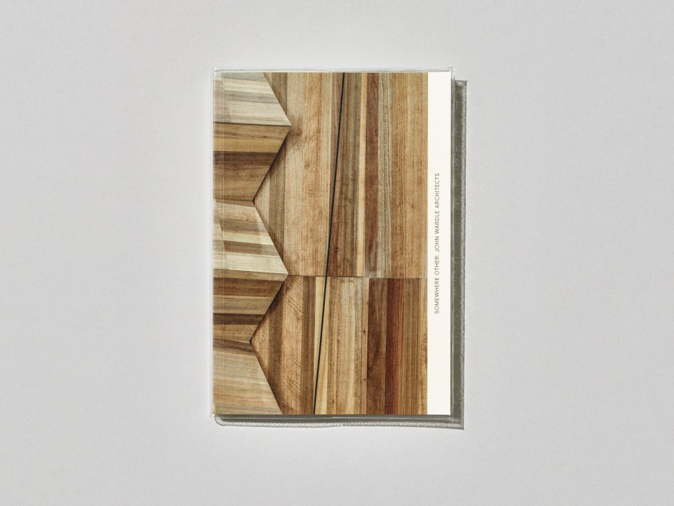 Somewhere Other book with wood grain cover showing geometric angular cuts and natural timber textures