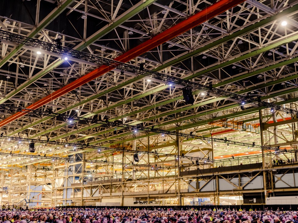 Interior view of Boeing's massive Everett factory showing enormous industrial space with crowds gathered below
