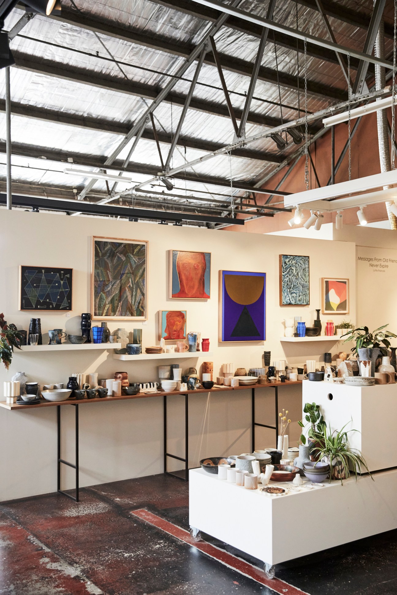 Interior of Boom Gallery in Geelong with artwork displayed on cream walls and shelving.