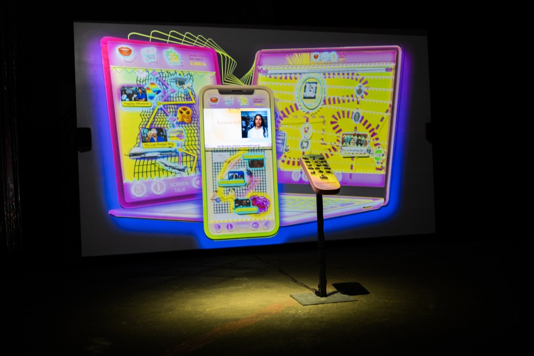 Gaming-inspired art installation by Neïl Beloufa featuring colorful digital screens and interactive elements in gallery