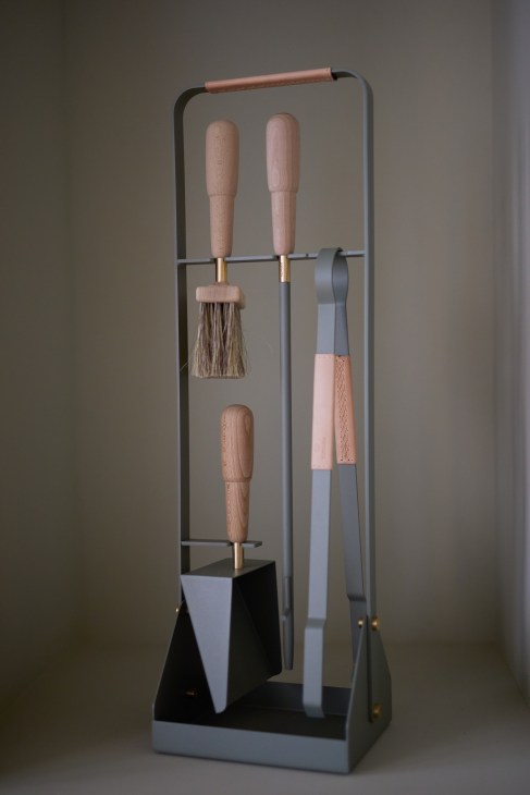 Eldvarm fireplace tools with wooden handles displayed on metal stand