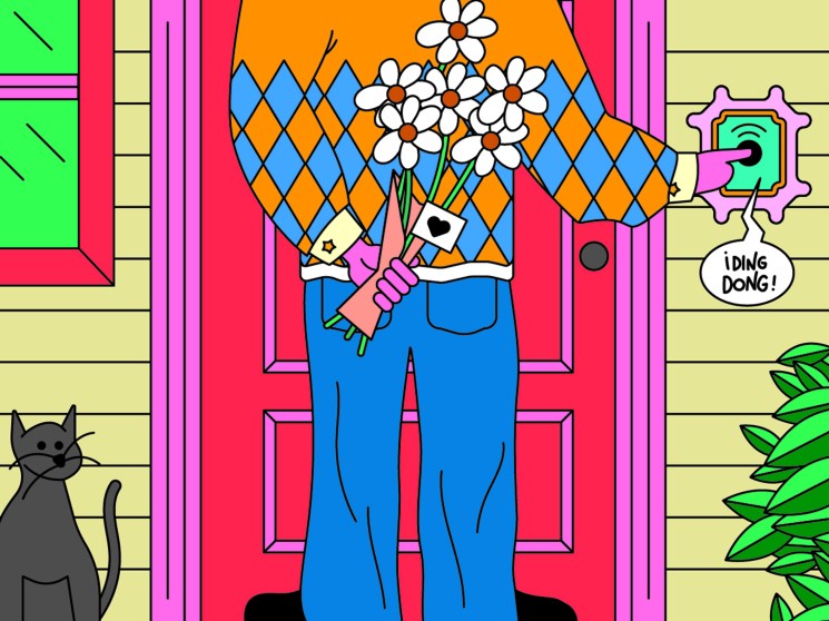 Person in colorful diamond-pattern sweater holding bouquet of white daisies at front door