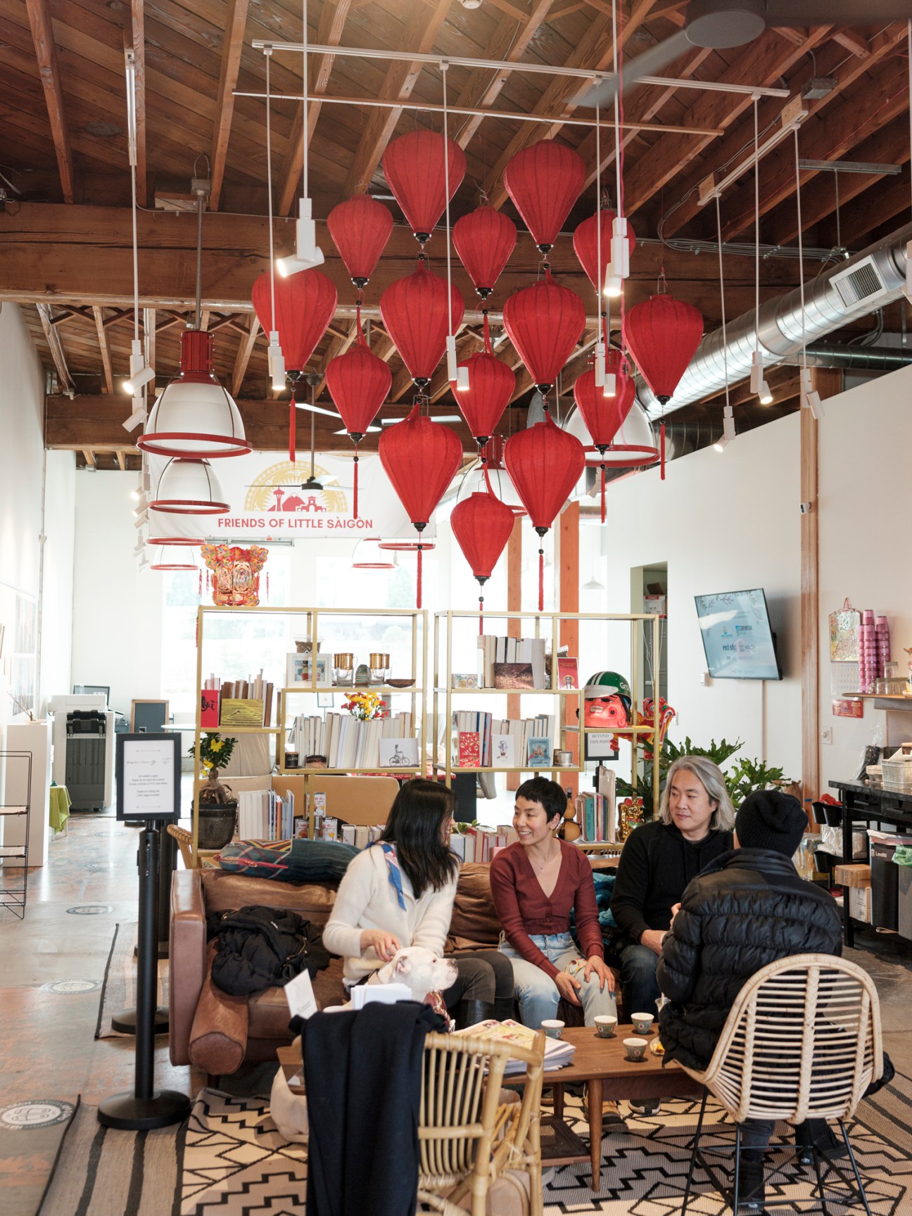 Interior of Little Saigon Creative community hub in Seattle with red lantern decorations and shelving.