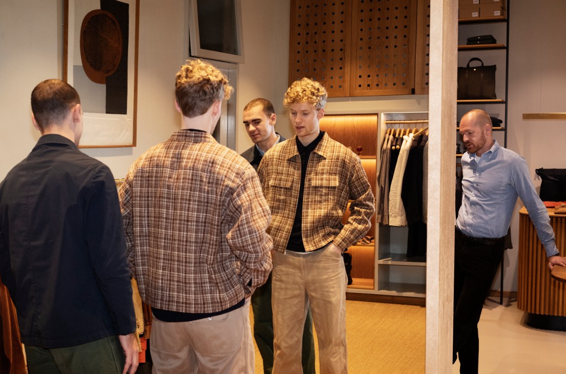 Customer Victor Hald trying on jacket from Auralee and trousers from Orslow in modern menswear store