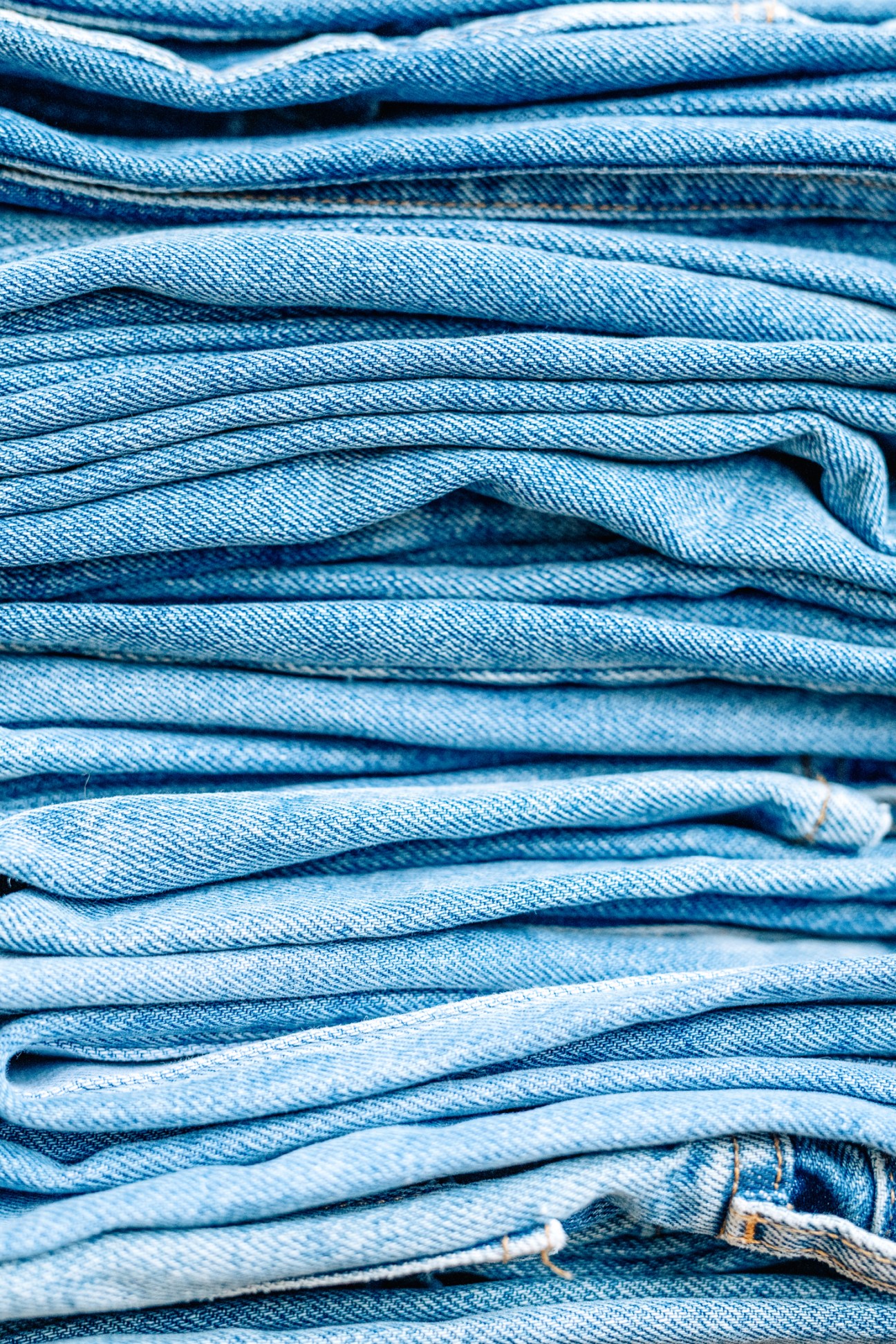 Folded denim jeans stacked on top of each other