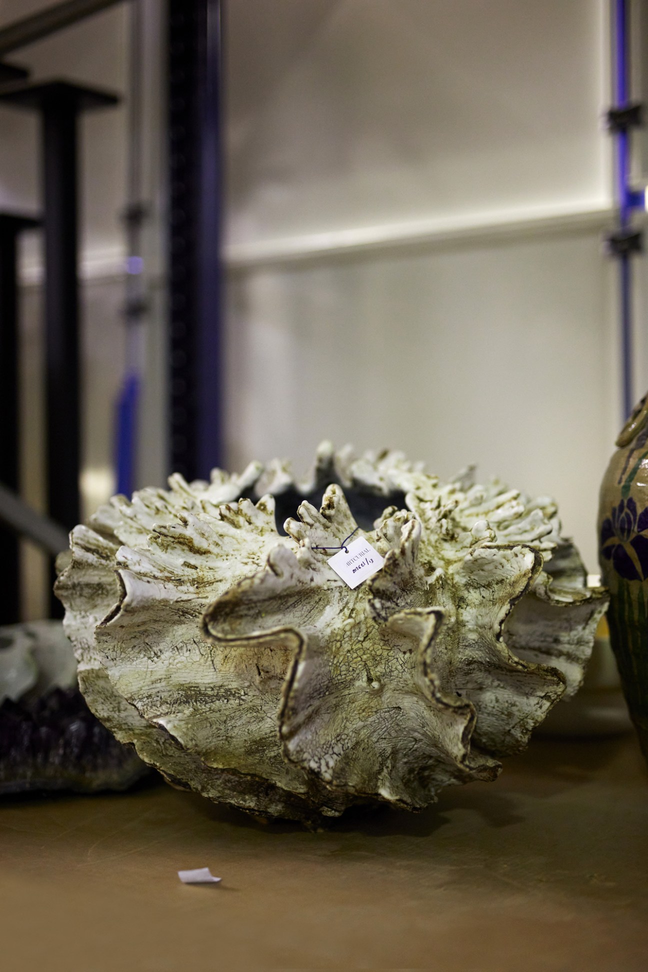 Large sculptural sandstone vase with organic shell-like ridged form by artist Shoko Koike