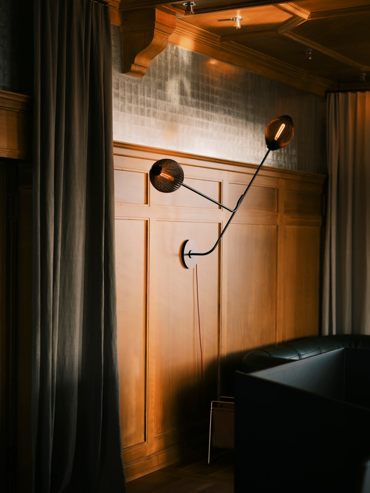 Modern wall-mounted lamp with geometric design and two adjustable black spherical lights on metal arms