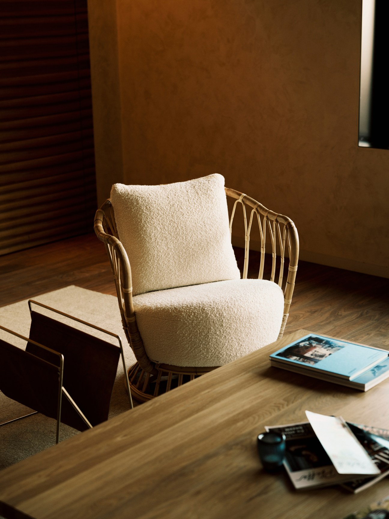 Grace lounge chair by Tove Kindt Larsen with cream cushions and rattan frame in warm sunlit room
