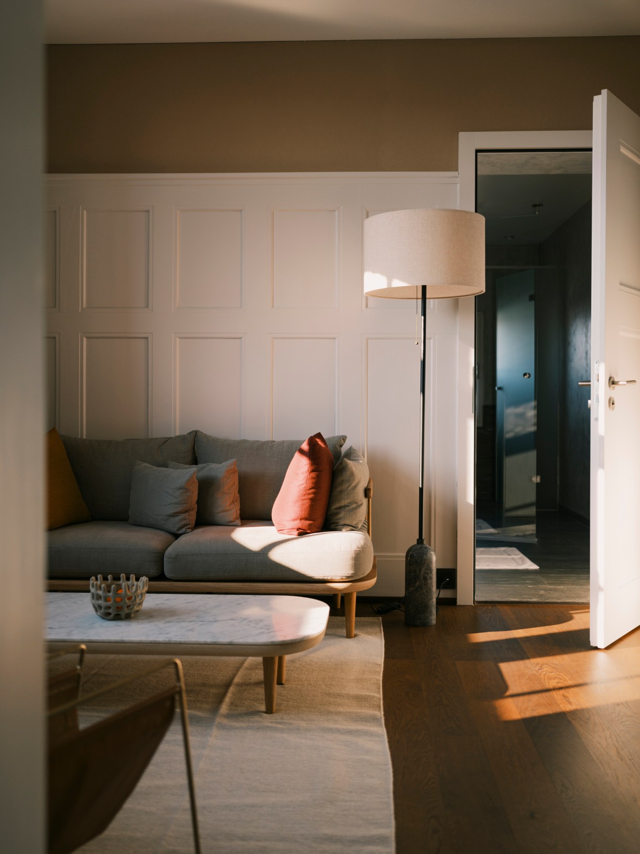 Stylish bedroom featuring modern sofa and designer floor lamp