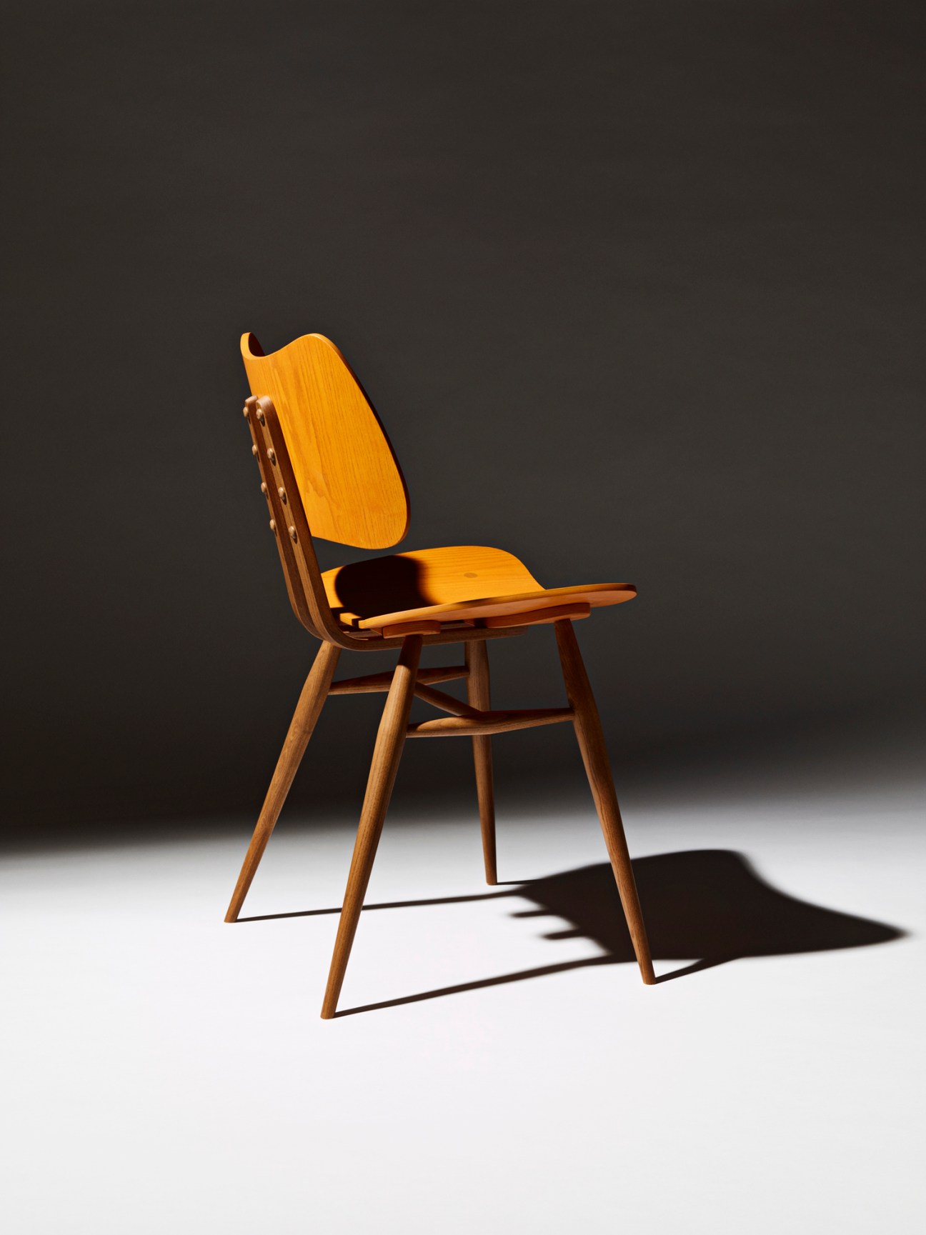 Ercol Butterfly chair in natural wood finish with curved steam-bent plywood seat and backrest