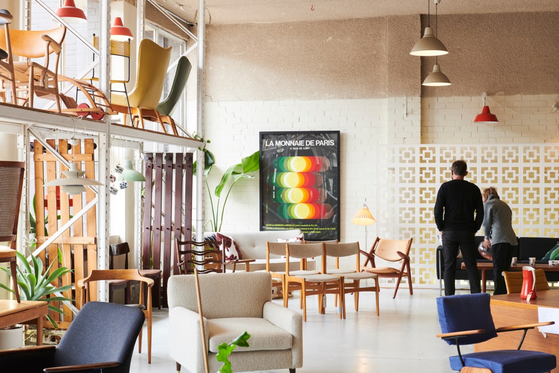 Interior of Grandfather's Axe mid-century furniture shop displaying wooden chairs, pendant lamps and vintage décor.