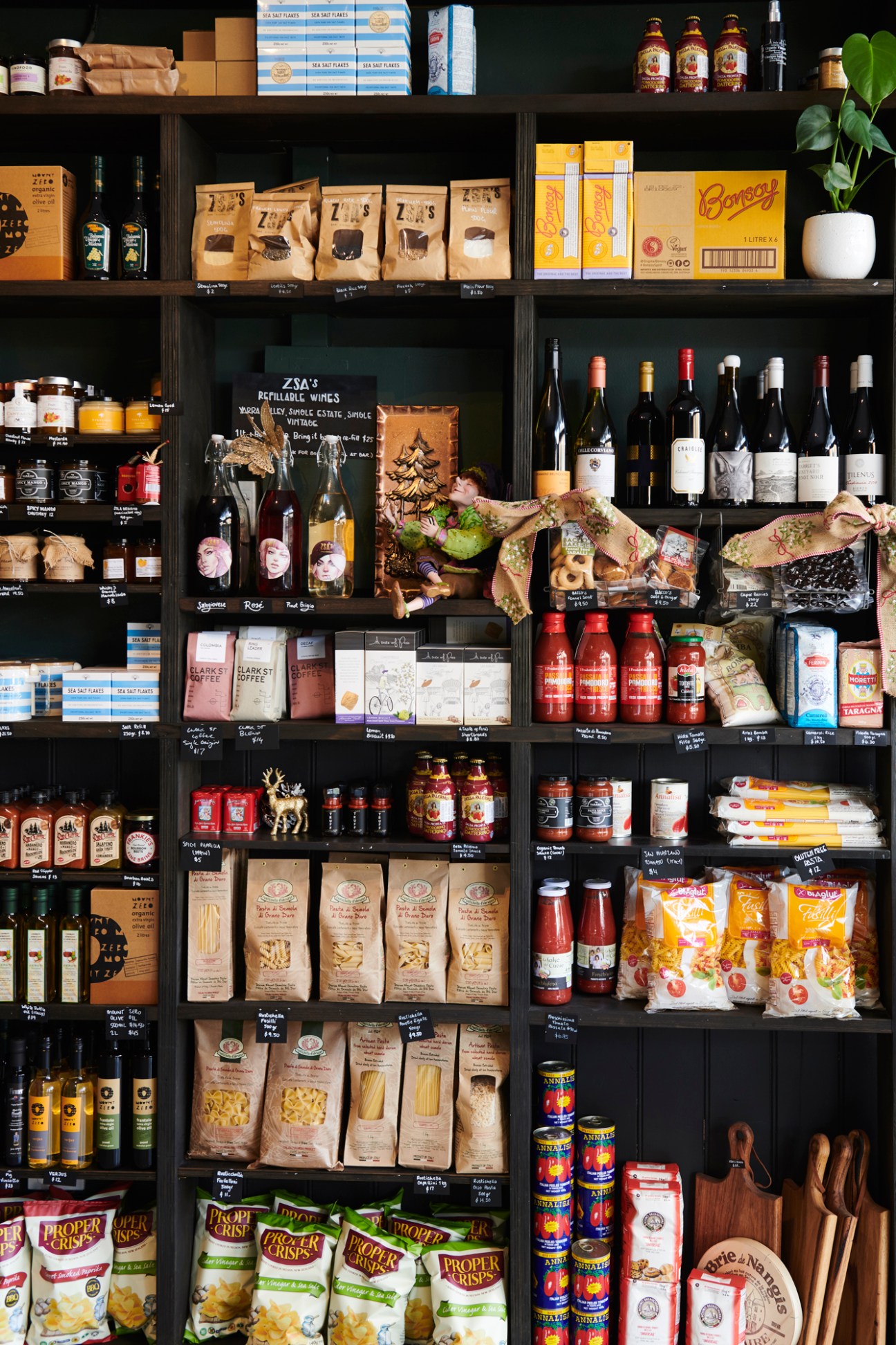Shelves displaying products at Zsa's European bistro and deli including wines, pasta, coffee and gourmet goods.